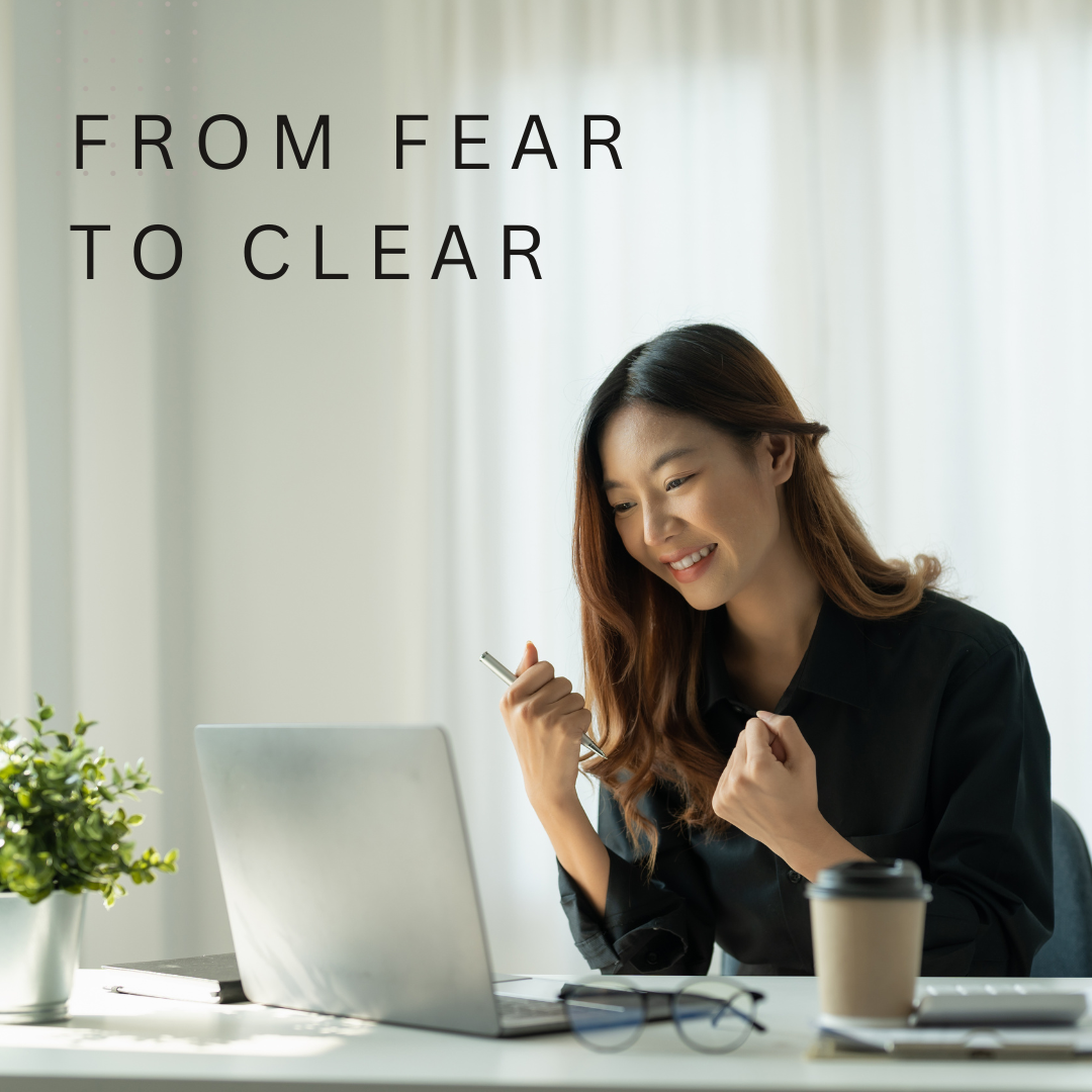 woman looking at her computer, fists clenched in "yes!" position.