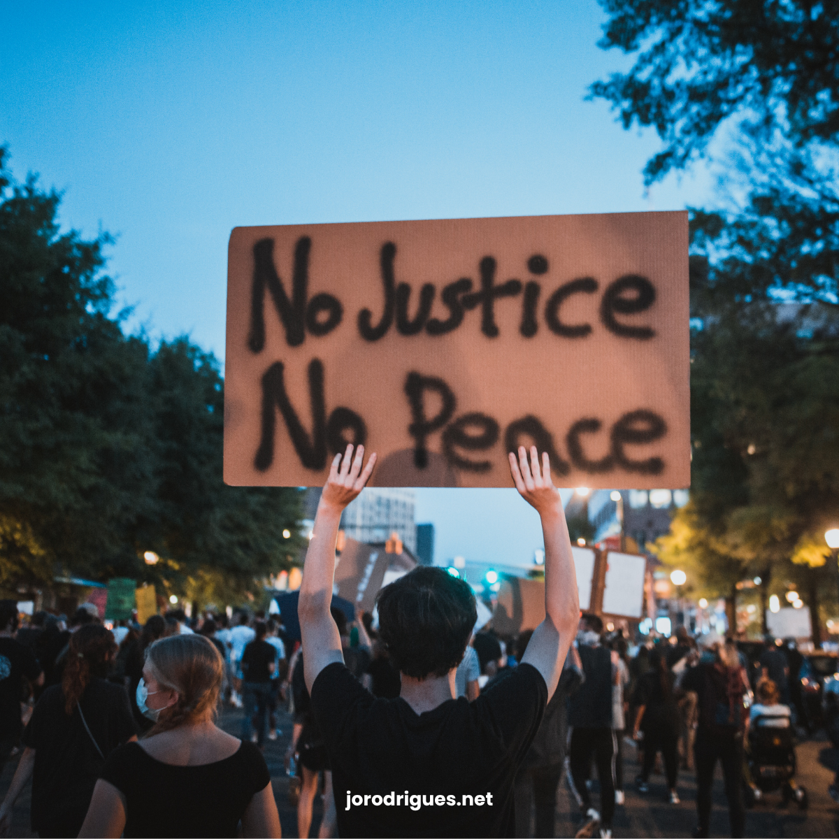 Back to viewer. People protesting on the street.